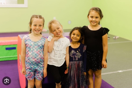 Four girls smiling at dance